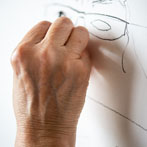 Lyn Carruthers making a self portrait in her studio in 2019
